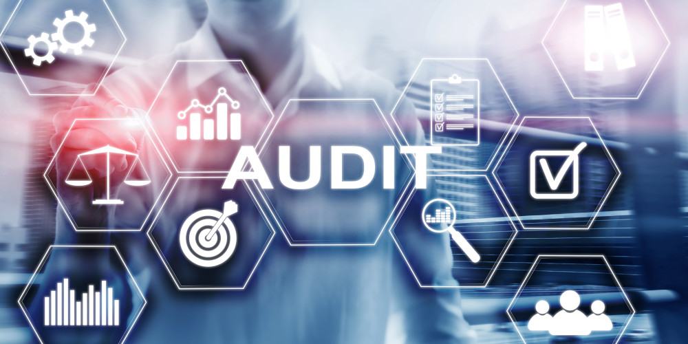Cybersecurity audit image with various symbols around the word "Audit"